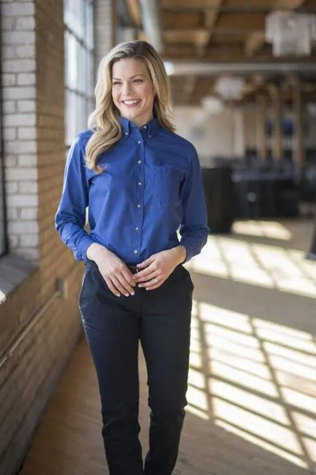 Woman Standing in a Work Uniform Looking Professional
