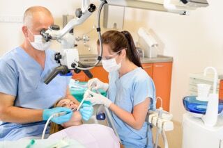 Dentists Working on a Patient and Wearing Nitrile Disposable Gloves