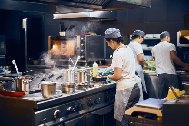 Chefs Cooking in the Restaurant with Culinary Uniforms