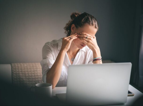 Woman Looking at a Laptop Stressed Out
