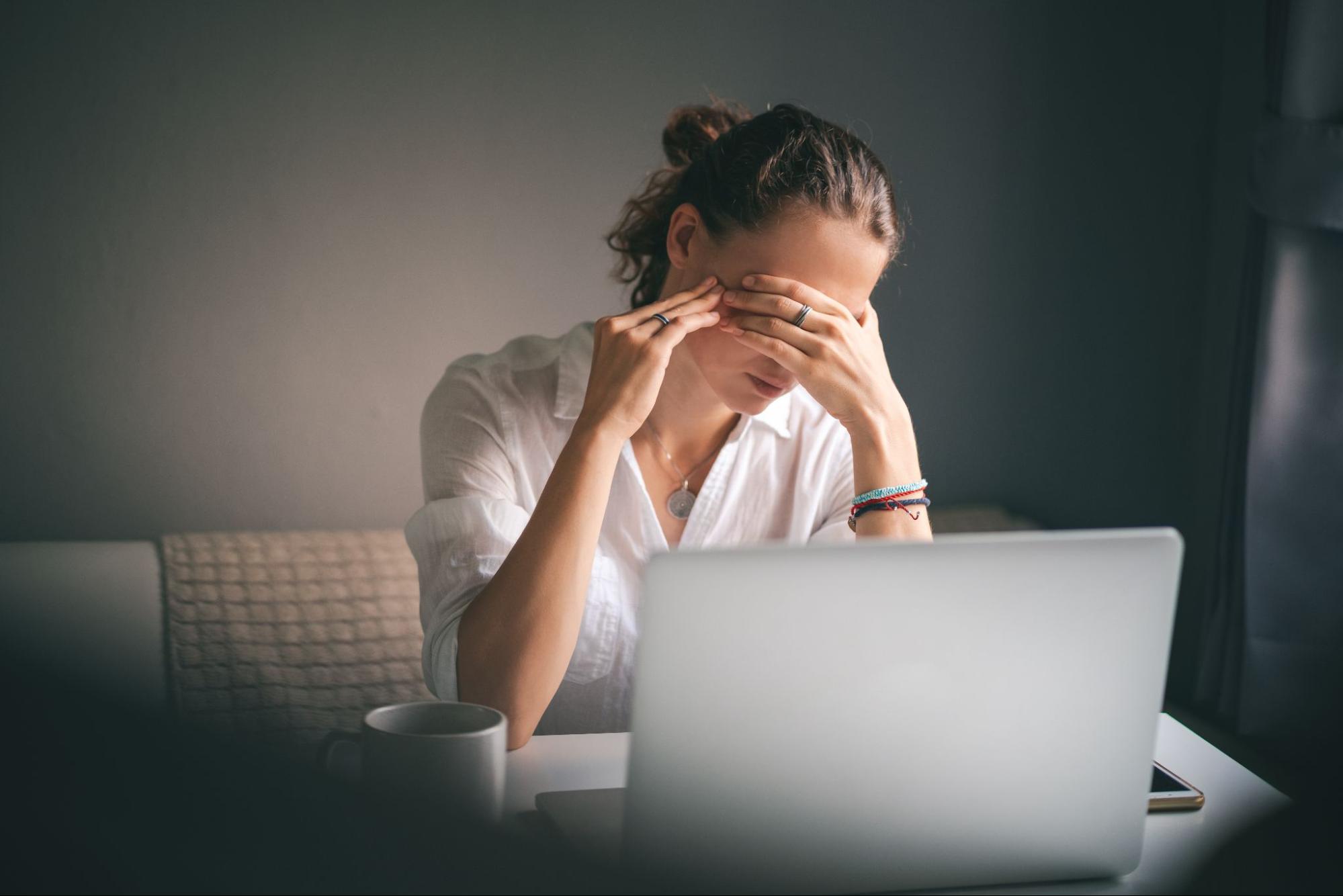 Woman Looking at a Laptop Stressed Out