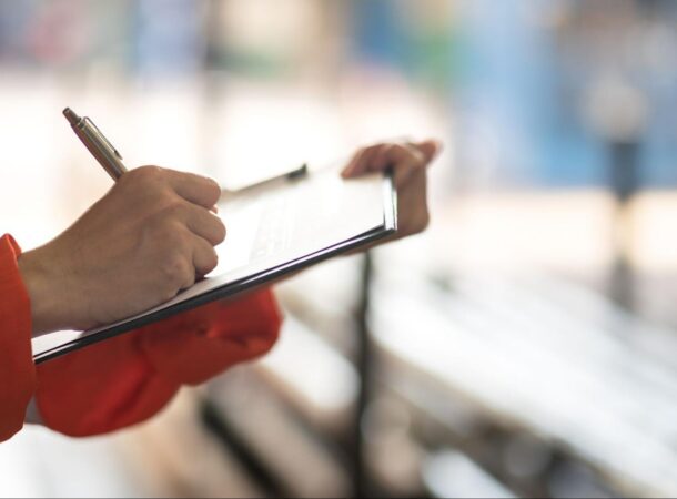 Workplace Manager Writing Notes About Improving the Company