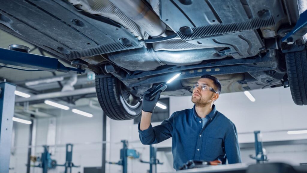 Automotive Technician Working on a Car in a Prudential Technician Shirt