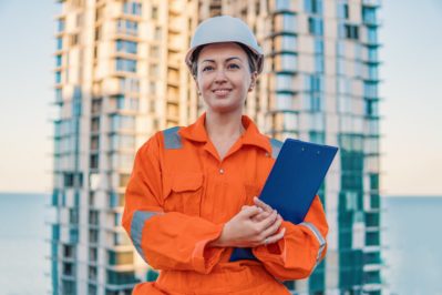 beatiful business woman engineer wearing orange coverall