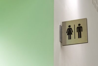 men and women toilet logo on the white wall