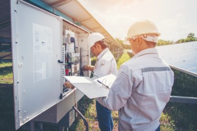 engineer checking and maintenance equipment in solar power plant