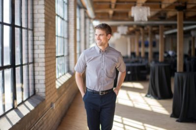 young confident businessman walking on the street