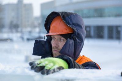 Close-up of a worker at the construction of an ice town for Christmas