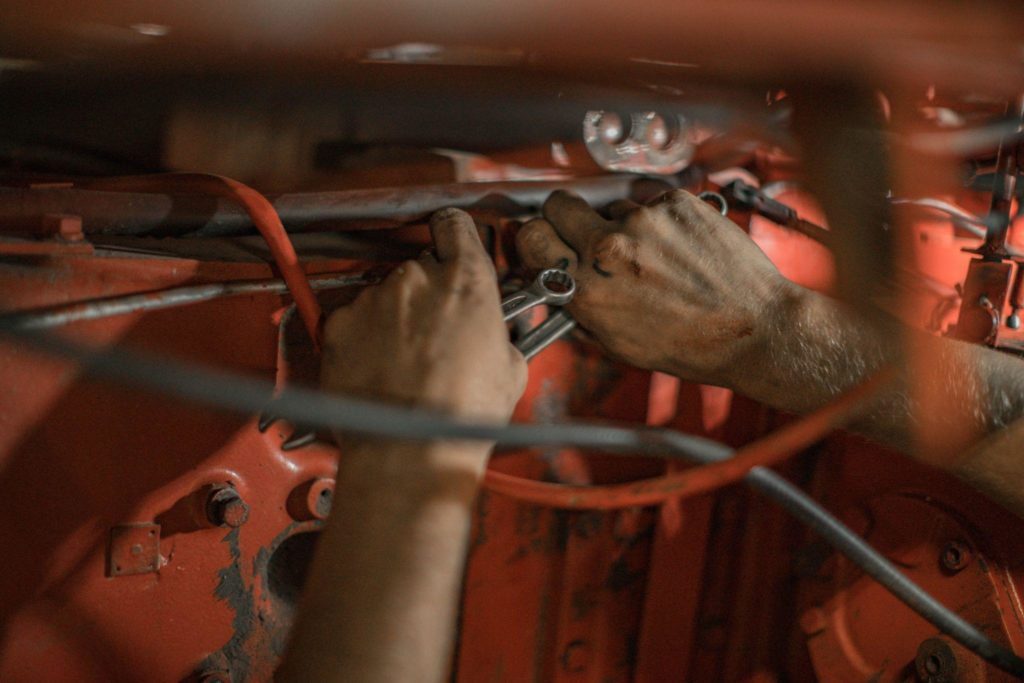 mechanic technician working at service station, repairing car