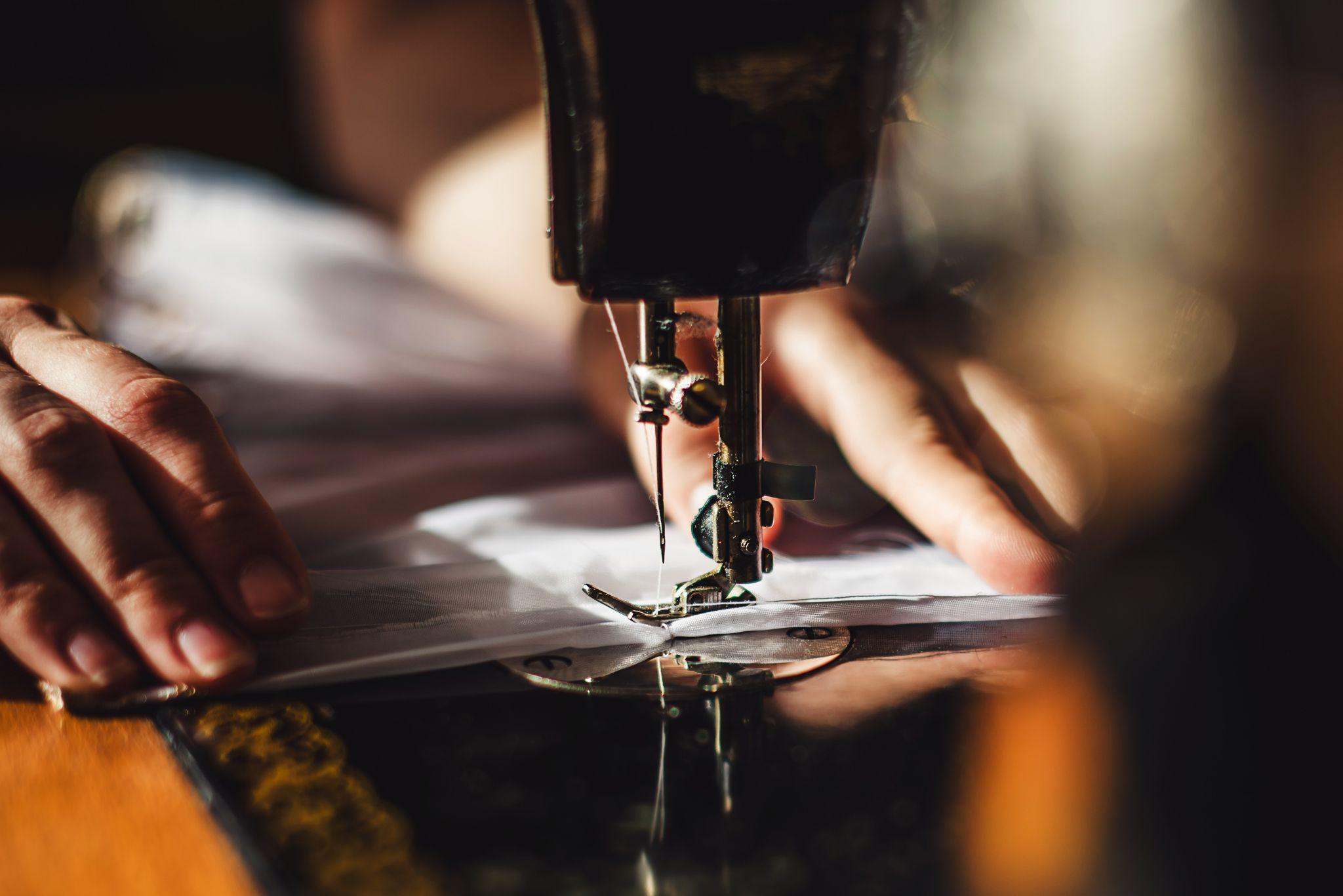 Sewing machine and woman's hands