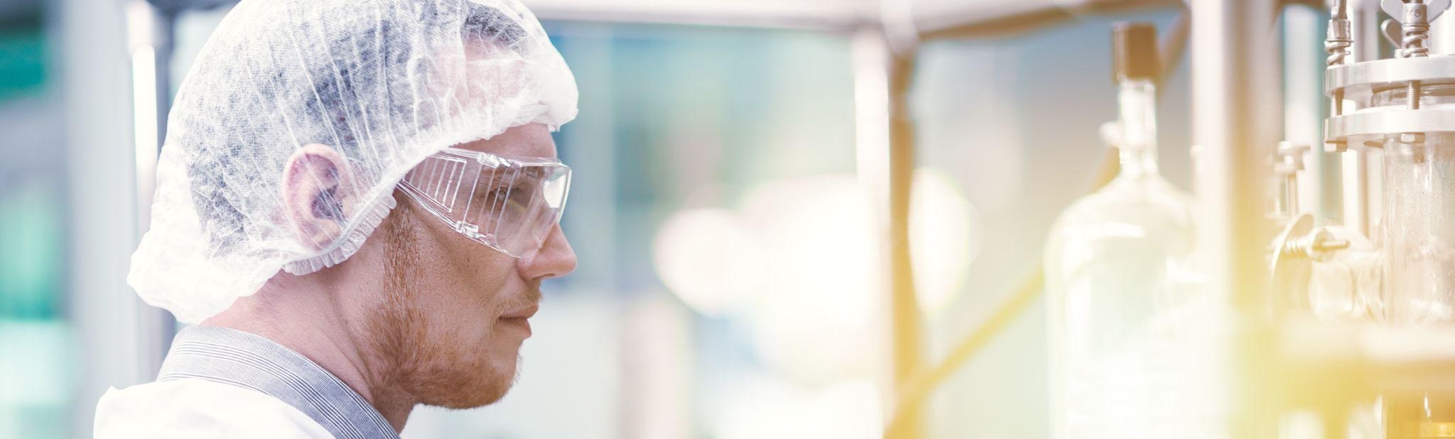 medicine factory scientist worker with Cannabis CBD oil extraction machine.