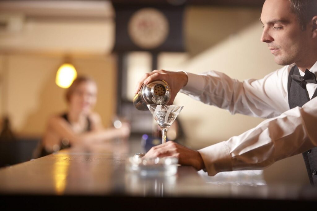 Restaurant Bartender in a Casino Pouring a Cocktail
