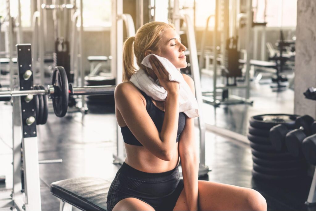 Woman Using a Gym Towel Laundered by Prudential Overall Supply